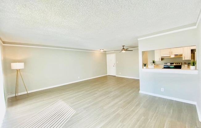 the spacious living room and kitchen of an apartment at The Flats on Addison, Sherman Oaks, CA