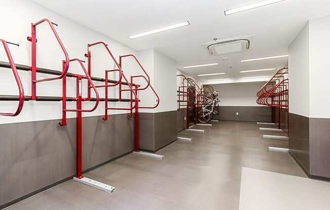 a row of red bike racks in a white walled room