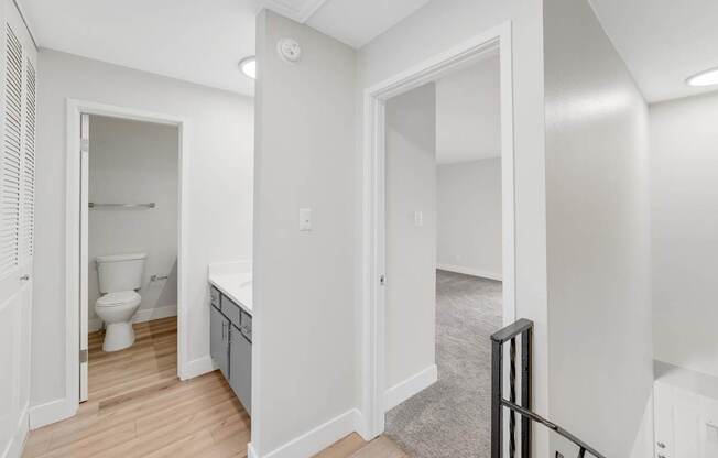 A white bathroom with a toilet and sink.