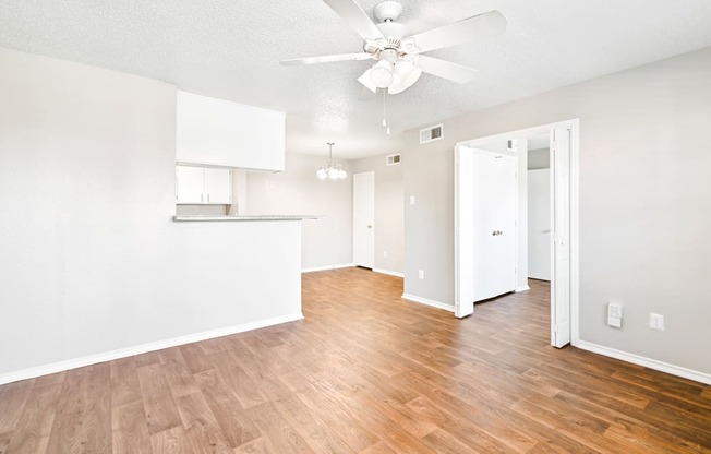 Brookstone Unit Living Area with Ceiling Fan at Bookstone and Terrace Apartments in Irving, Texas