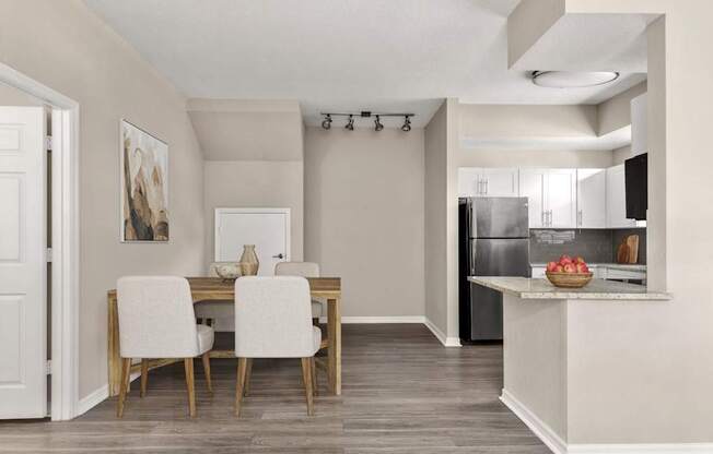 A modern kitchen with a dining table and chairs.