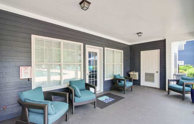 a patio with chairs and a table