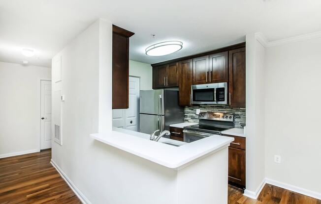a kitchen with a sink and a mirror