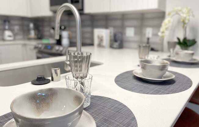 A modern kitchen with a white countertop and a bowl on it.