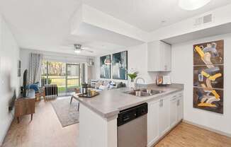 A modern kitchen with a large island and a painting on the wall.