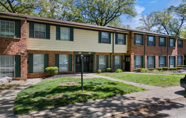 an apartment building with a sidewalk in front of it