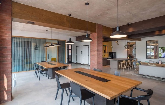 a living room and dining room with wooden tables and chairs