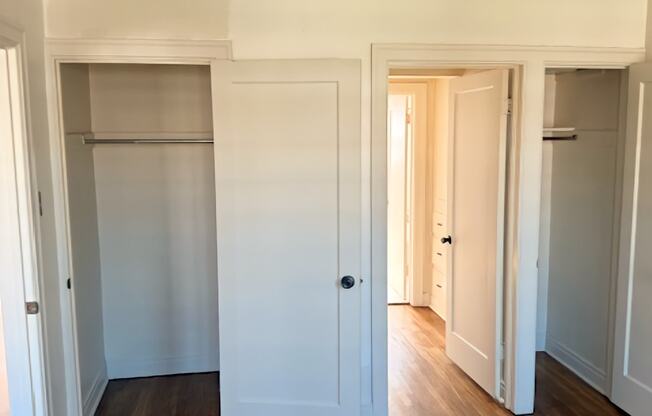 A room with white walls and wooden floors.