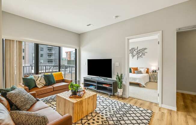 a living room with a couch and a tv at EagleRidge Plaza Residences, Fargo, ND