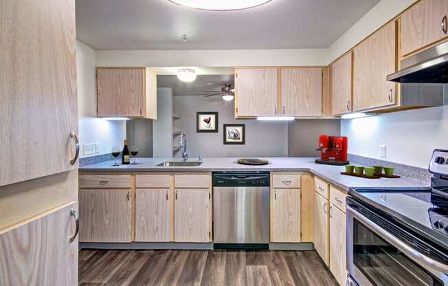 spacious kitchen with wood cabinets and stainless steel appliances at the preserve at great neck apartments