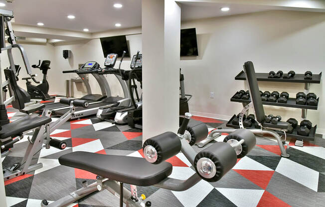 fitness room with weights and cardio machines