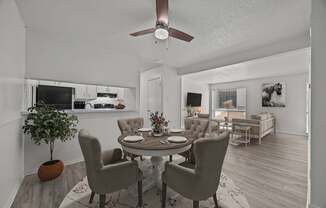A dining room with a round table and chairs.