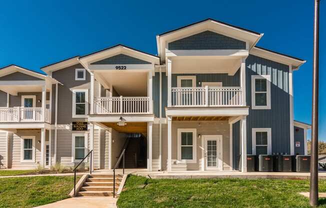 an apartment building with stairs and a sidewalk in front of it at Village at Westland Cove Apartments, Knoxville, TN