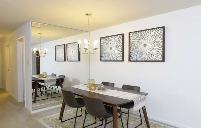 Dining room with a dining table and chairs and a wall with artwork at Village of Pine Run Apartments & Townhomes*, Maryland, 21244