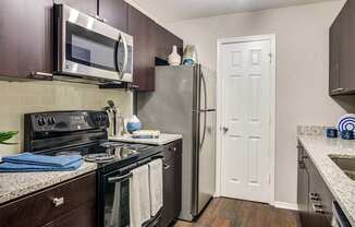 a kitchen with stainless steel appliances and a refrigerator