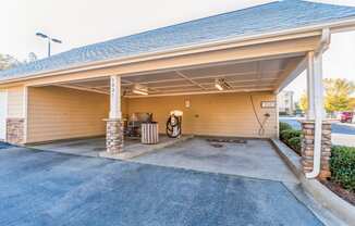 a car garage with an open door and a driveway