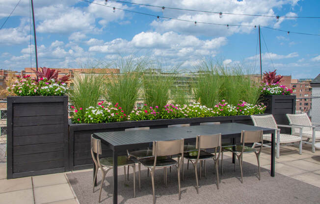 a patio with a table and chairs on a roof