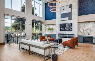 a living room with a couch and chairs and a fireplace