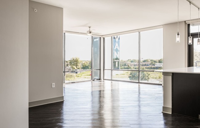 a living room with glass doors and a view of a city