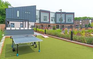 a tennis court with a ping pong paddle in the middle of it in front of a