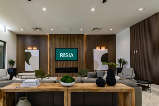 a lobby with a reception desk and a couch and a table