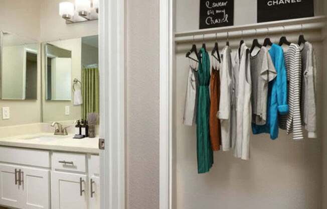 Clothes hanging on a rack in a room.