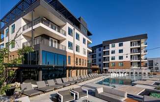A modern building with a pool in front.