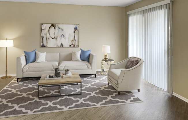 a living room with a couch chair and coffee table