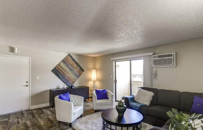 a living room with a couch and chairs and a table