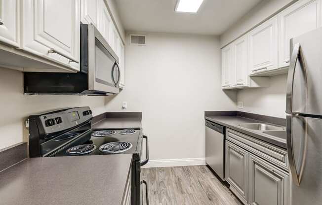 a kitchen with stainless steel appliances and white cabinets