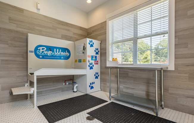 a bathroom with a shower and a sink and a window
