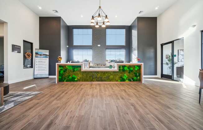 a large lobby with a reception desk and a large window