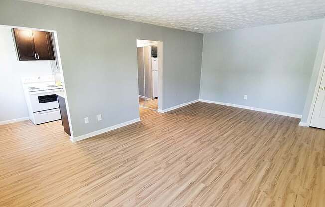 A room with wooden flooring and a built-in oven.