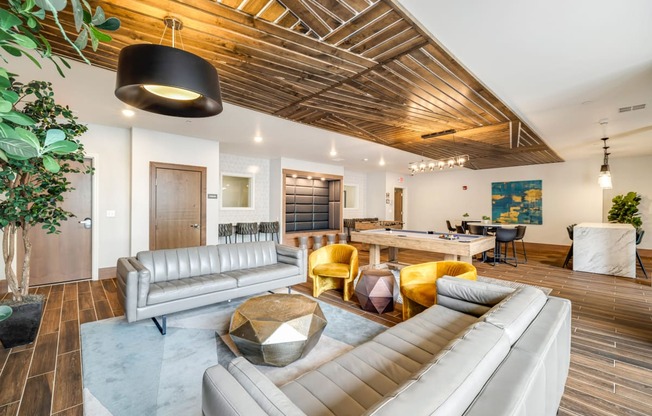 a living room with couches and chairs and a table