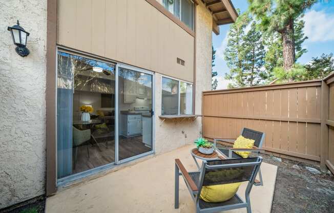 a patio with two chairs and a table on it