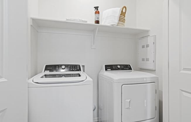a small laundry room with two washes and a dryer