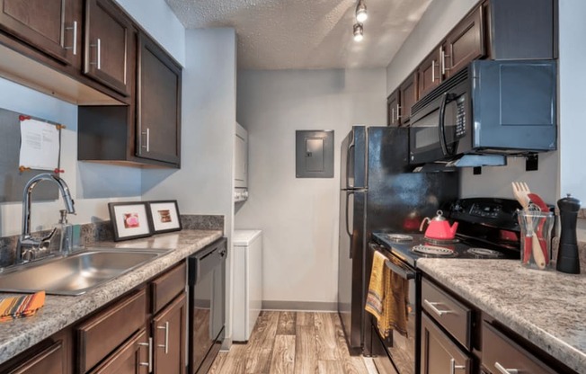 a kitchen with stainless steel appliances and granite counter tops at Brightwaters Apartments, Little Rock, 72202