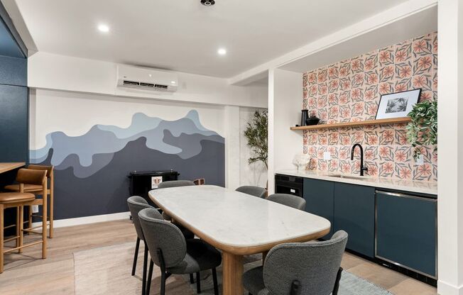 A dining room with a table and chairs.