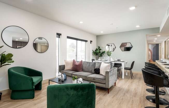 a living room with a couch and chairs and a dining room table