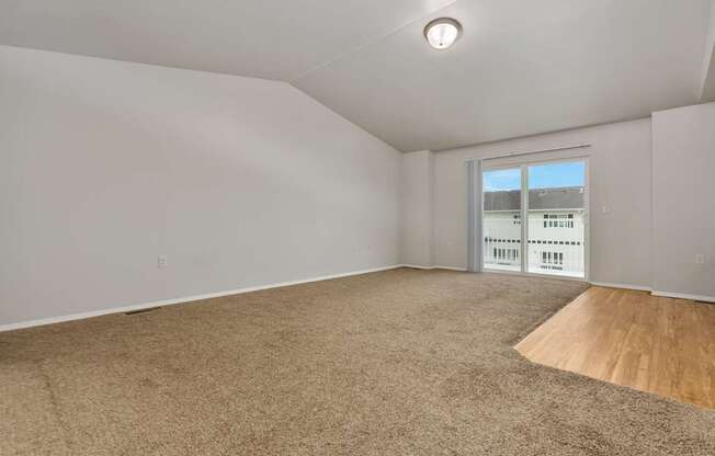 Empty room with carpeted floor and a window.