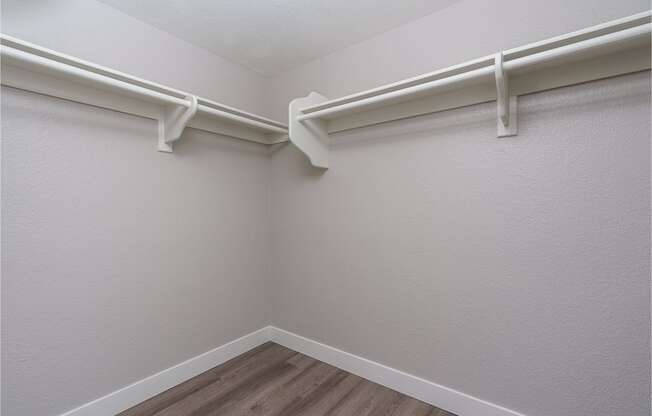 renovated walk in closet with plank style flooring