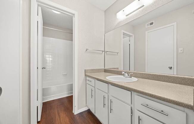 A bathroom with a sink, mirror, and cabinets. at Montecito, Texas, 78741