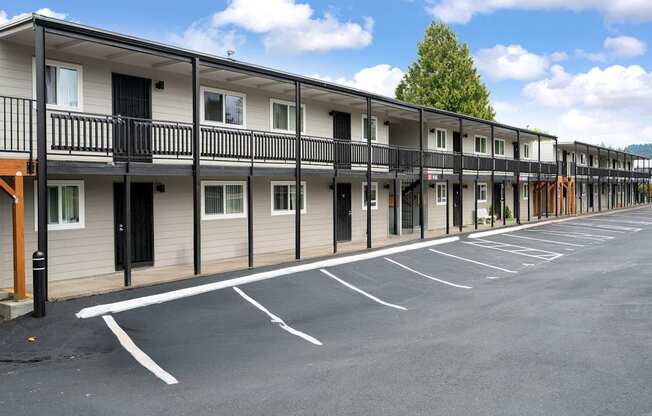 A parking lot in front of a row of townhouses.
