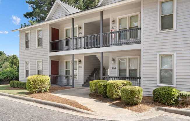 A two-story building with a balcony on the second floor.