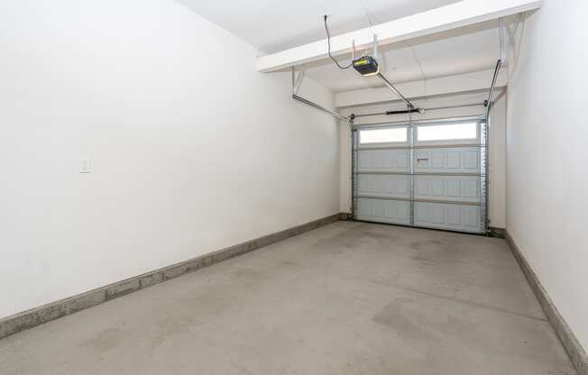 a large empty room with a garage door