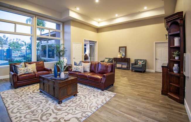 A living room with brown leather couches and a patterned rug.