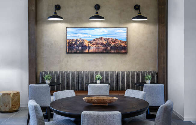 A dining room with a large table and chairs.