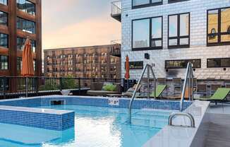 A swimming pool with a blue tiled edge and a metal ladder.
