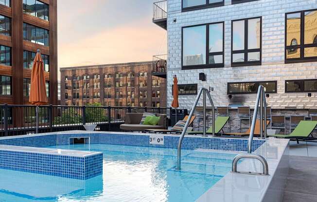 A swimming pool with a blue tiled edge and a metal ladder.