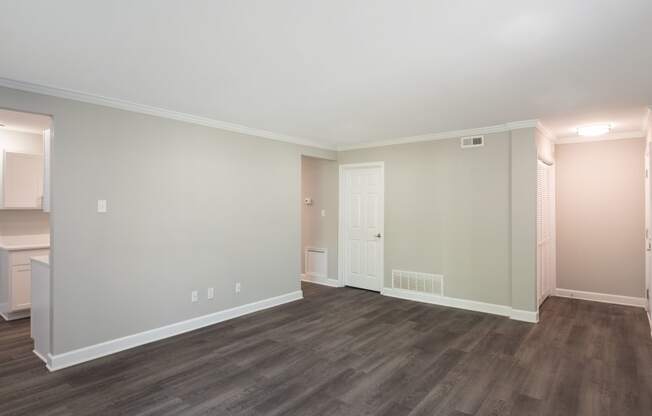 a bedroom with hardwood floors and grey walls